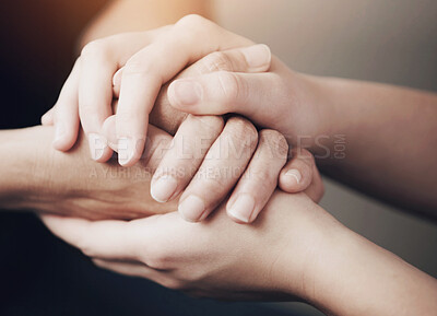 Buy stock photo Cropped shot of two people holding hands in comfort