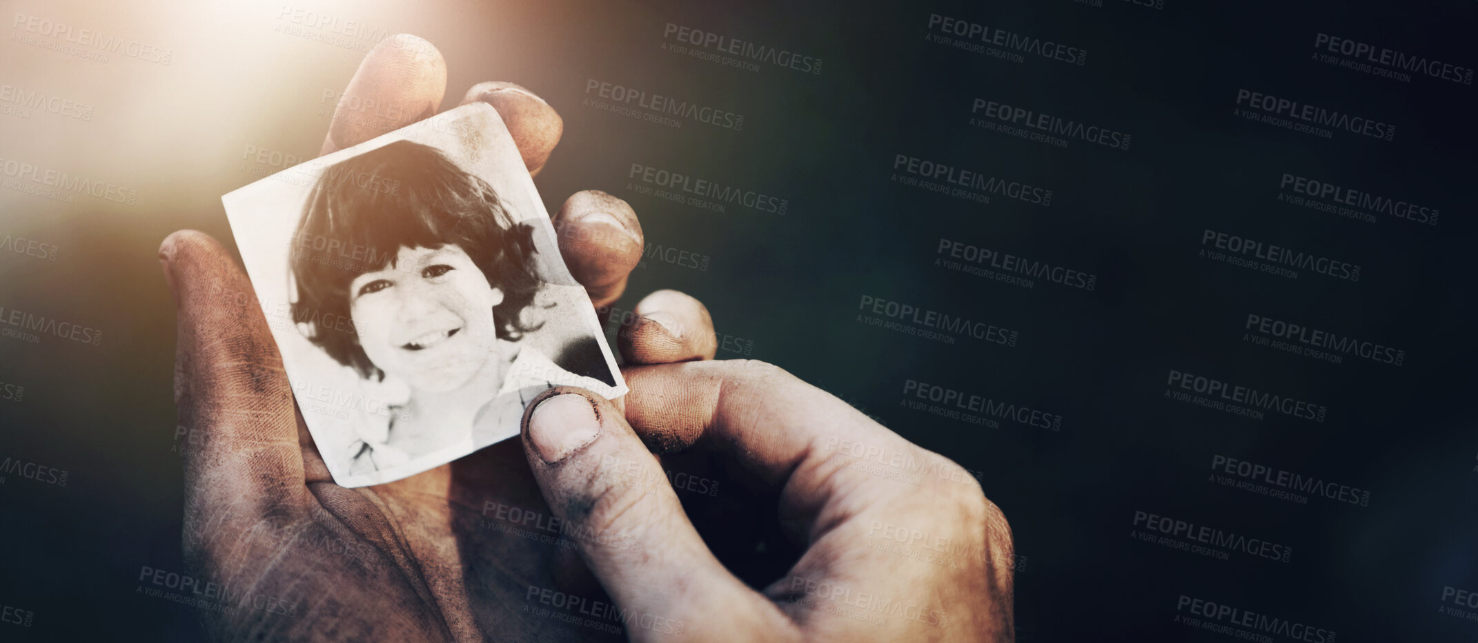 Buy stock photo A dirty hand holding a black and white picture of a little boy