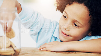 Buy stock photo A cute young boy grabbing a cookie from the cookie jar