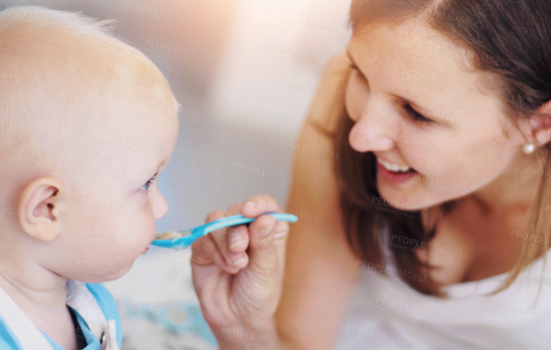 Buy stock photo Mother, baby and feeding food, breakfast and eating for healthy nutrition in home. Happy mom, newborn and feed hungry child, infant or toddler meal with a spoon for growth, development and wellness.