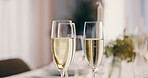 Alcohol, champagne and glasses on table at party for celebration, social event and gathering. Fine dining, luxury and liquor bubbles for cheers, toast and drinks at gala, new years eve and dinner