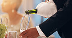 Waiter, hands and champagne in glass at restaurant for new year party, gala event and fine dining. Catering service, server and person pour sparkling alcohol drink at social gathering for hospitality