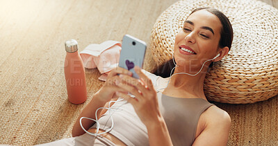 Buy stock photo Music, phone and relax with woman in home gym for streaming, exercise podcast and peace. Fitness, internet and wellness app with person listening to zen audio for mental health, yoga and pilates