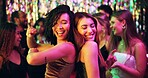 Dancing, party and friends in club, night and fun for women, bonding and celebration in weekend or group. Lights, dark and listening to music, dancer and people in rave, disco or festival in New Year