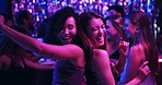 Dancing, energy and friends in club, night and fun for women, bonding and celebration in weekend or group. Lights, dark and listening to music, smile and people in rave, disco or festival in New Year