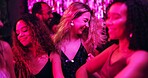 Dancing, group and friends in club, night and fun for women, bonding and celebration in weekend or smile. Lights, dark and listening to music, dancer and people in rave, disco or festival in New Year