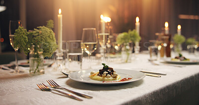 Buy stock photo Plate, food and empty dinner table at event with catering, candles and service for gala at night. Meal, party and glass for water, alcohol or drinks with luxury, interior or furniture for fine dining