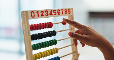 Buy stock photo Hand, abacus and child learning math for brain development, study or arithmetic. Kid, person and calculate with beads for education, knowledge or student counting numbers in elementary school closeup