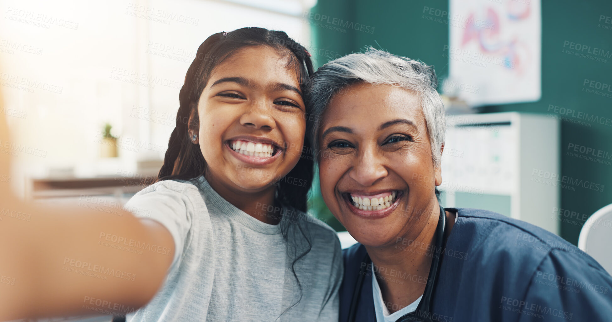 Buy stock photo Mature woman, doctor and selfie with girl as patient with smile at clinic for social media and profile picture. People, pediatrician and happy with kid on portrait, confidence or pride for healthcare