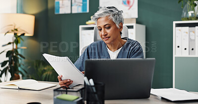 Buy stock photo Doctor, laptop and mature woman with paperwork in office for healthcare, research or patient records. Medical professional, reading and work with info by tech for diagnosis review, report or feedback