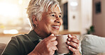 Senior woman, home and thinking with coffee for peace, quiet and comfortable couch in retirement. Female person, nostalgia and contemplating with cappuccino for calm, hot chocolate and mindfulness