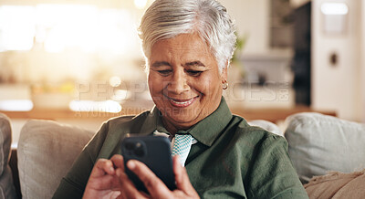 Buy stock photo Old woman, relax and phone for typing in home, reading notification and texting on app. Female person, senior lady and couch for scrolling on social media, funny ebook and website for news update