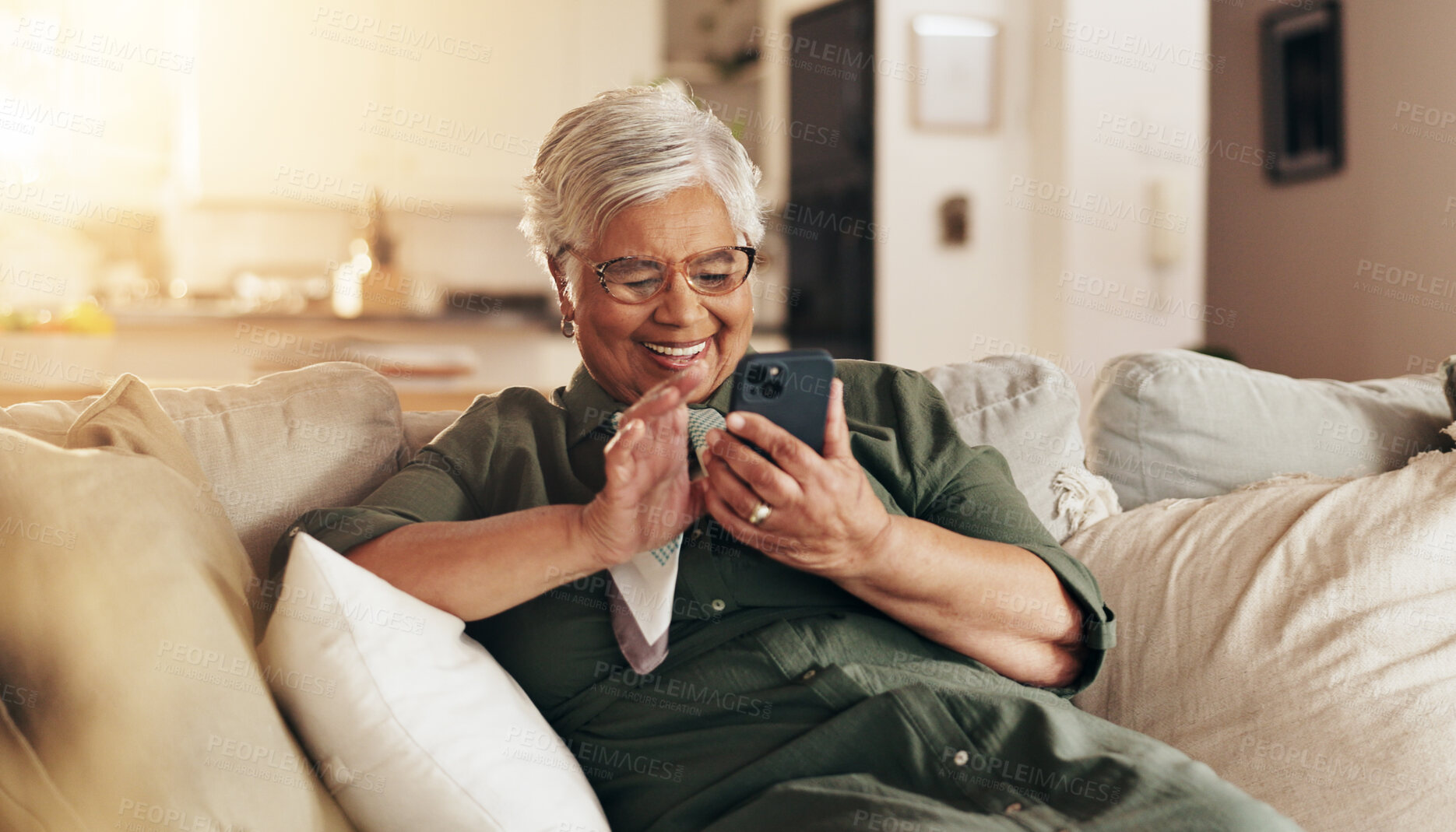 Buy stock photo Old woman, relax and phone for communication in home, reading notification and texting on app. Female person, senior lady and couch for scroll on social media, funny ebook and website for news update