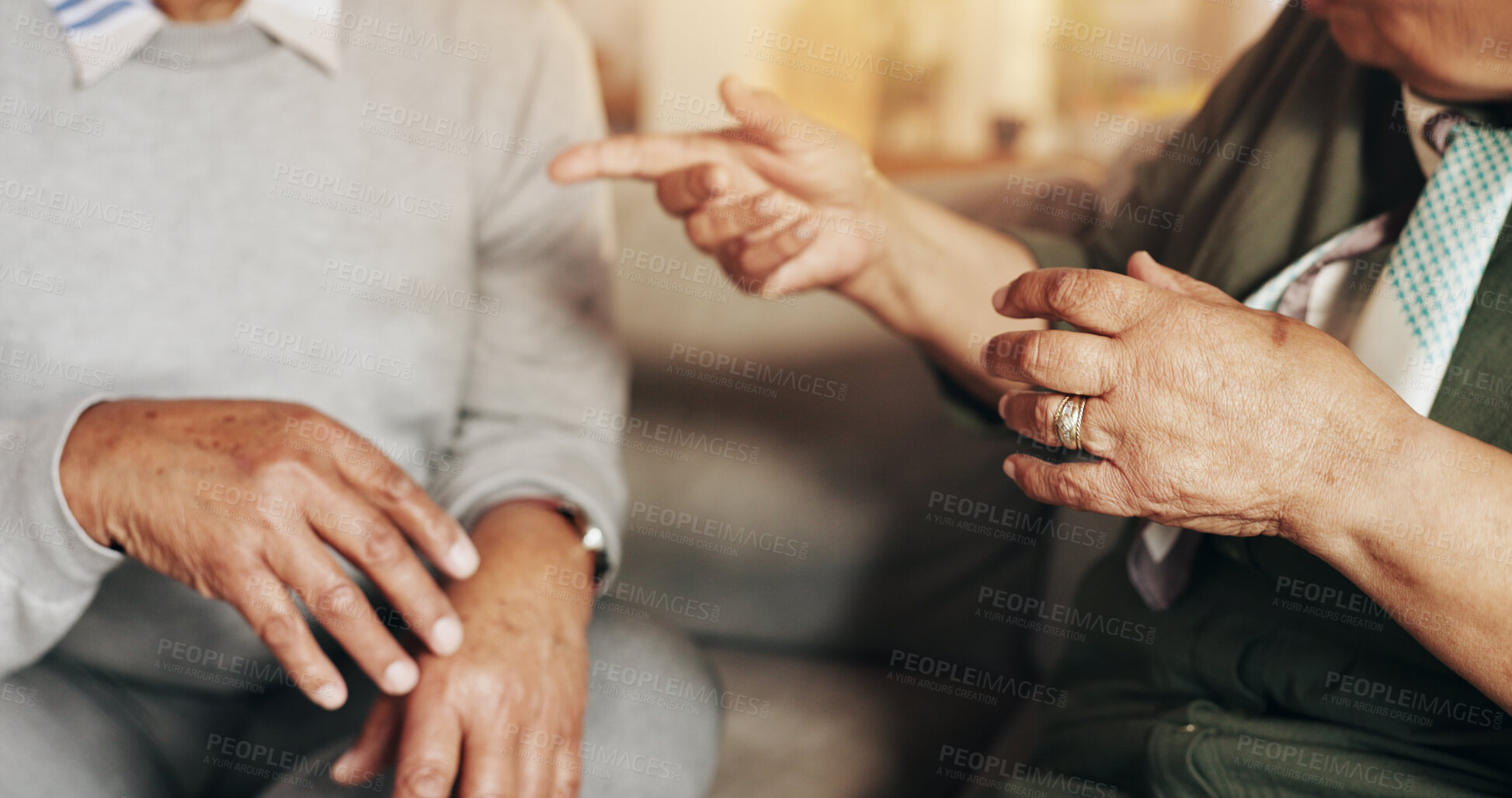 Buy stock photo Senior, couple and hands with conflict in home for disagreement, fight and pointing in conversation. Elderly people, argument and discussion on sofa with marriage fail, divorce or relationship crisis