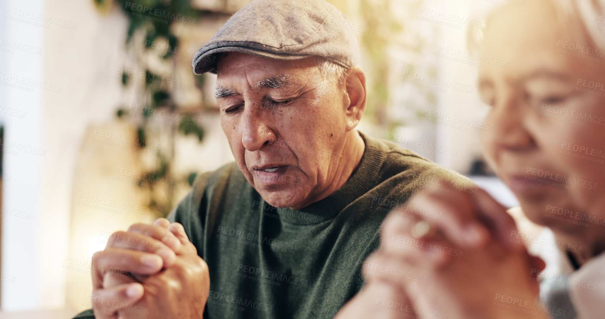 Buy stock photo Christian, praying and old couple with faith, home and respect for God, worship and gratitude for holy spirit. Retirement, man and woman with praise to Jesus, talking and peace with belief and heaven