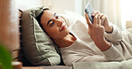 Cellphone, relax and woman on bed in home with social networking, browsing and swiping on dating app. Calm, rest and female person laying in bedroom with phone for reading online blog in apartment.