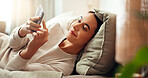 Cellphone, rest and woman on bed in home with social networking, browsing and swiping on dating app. Calm, relax and female person laying in bedroom with phone for reading online blog in apartment.