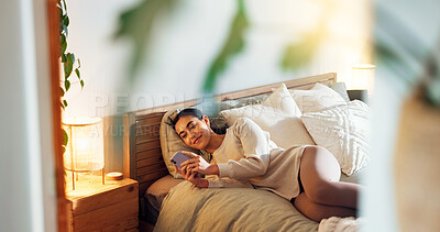 Buy stock photo Smartphone, rest and woman on bed in home with social networking, browsing and swiping on dating app. Calm, relax and female person laying in bedroom with phone for reading online blog in apartment.