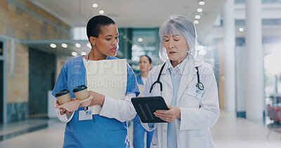 Buy stock photo Doctors, women and tablet for medical plan in hospital, coffee and walking to surgery with papers. People, clinic staff and online for healthcare treatment, talking and team for cardiology research