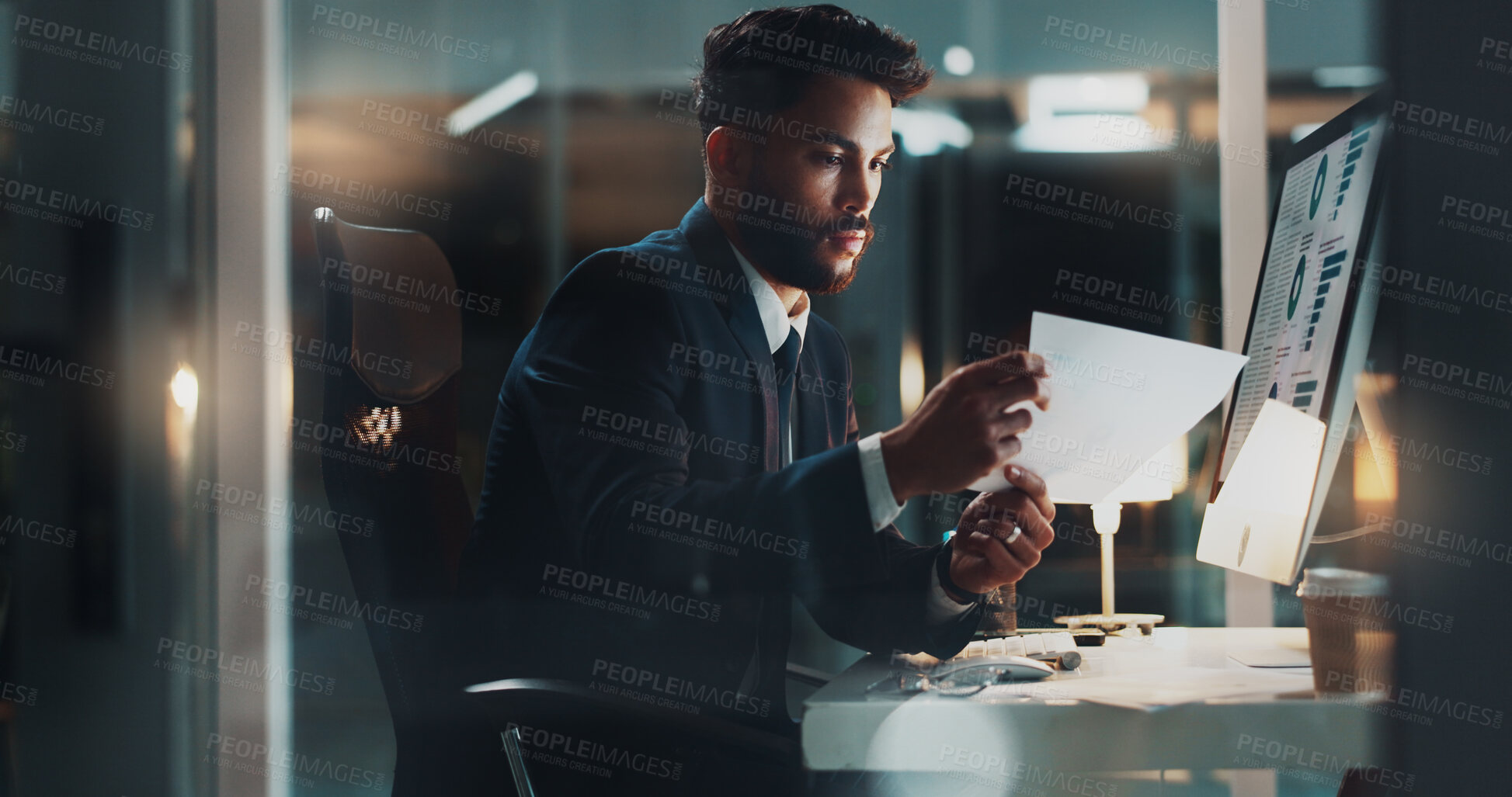 Buy stock photo Night, man and paper at computer for business, research and reading report presentation plan with stats on screen. Accountant, tech and document in dark office with results for company finance growth