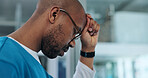 Black man, doctor and stress in hospital for healthcare, mistake and regret in surgery. Surgeon, glasses and depression at window for crisis, overwhelmed and pressure with mental health awareness