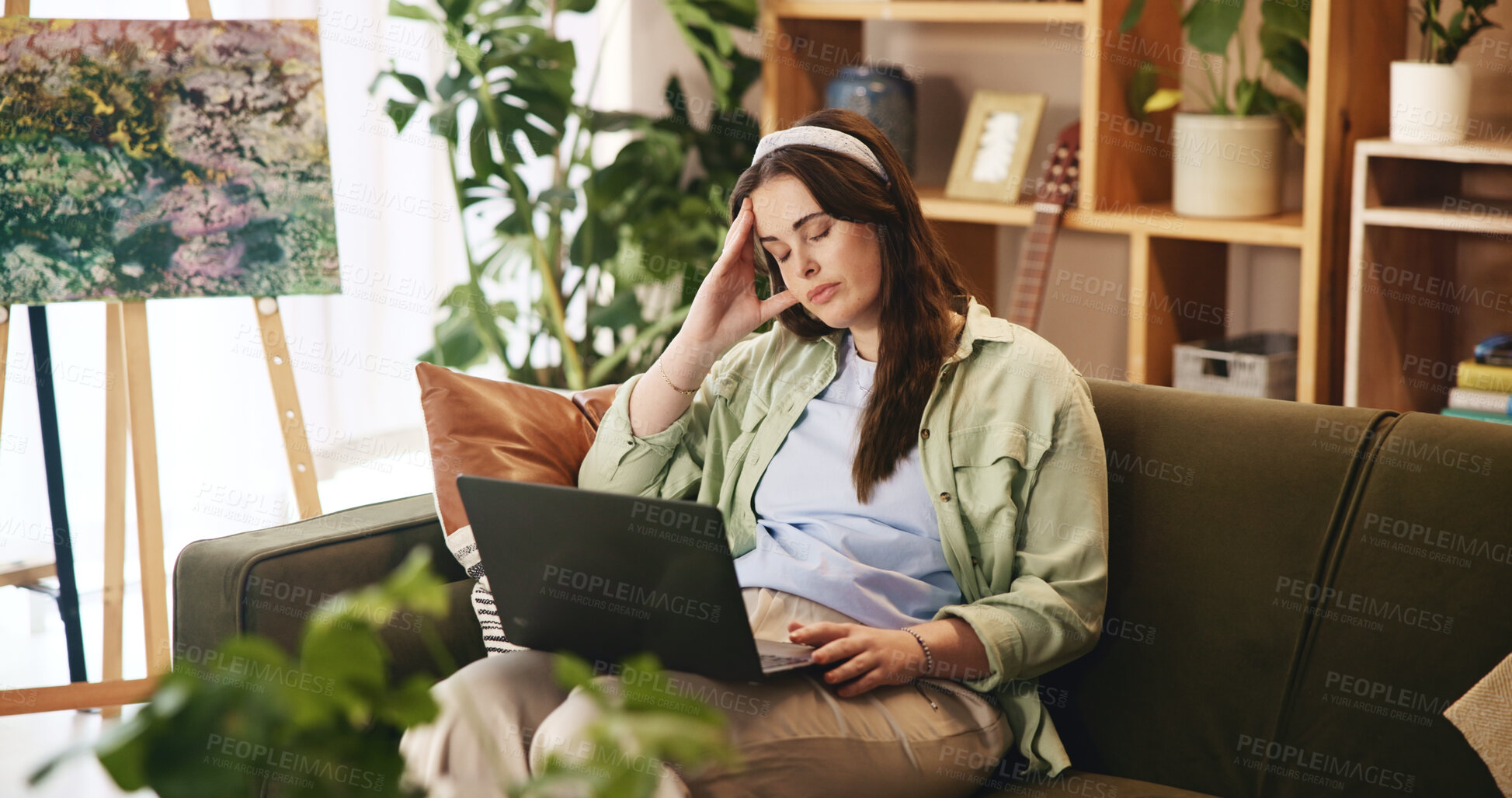 Buy stock photo Stress, university and woman on sofa with laptop with headache for exam, test and assessment for college. Burnout, home and girl with worry, frustrated and pain for studying, education and learning
