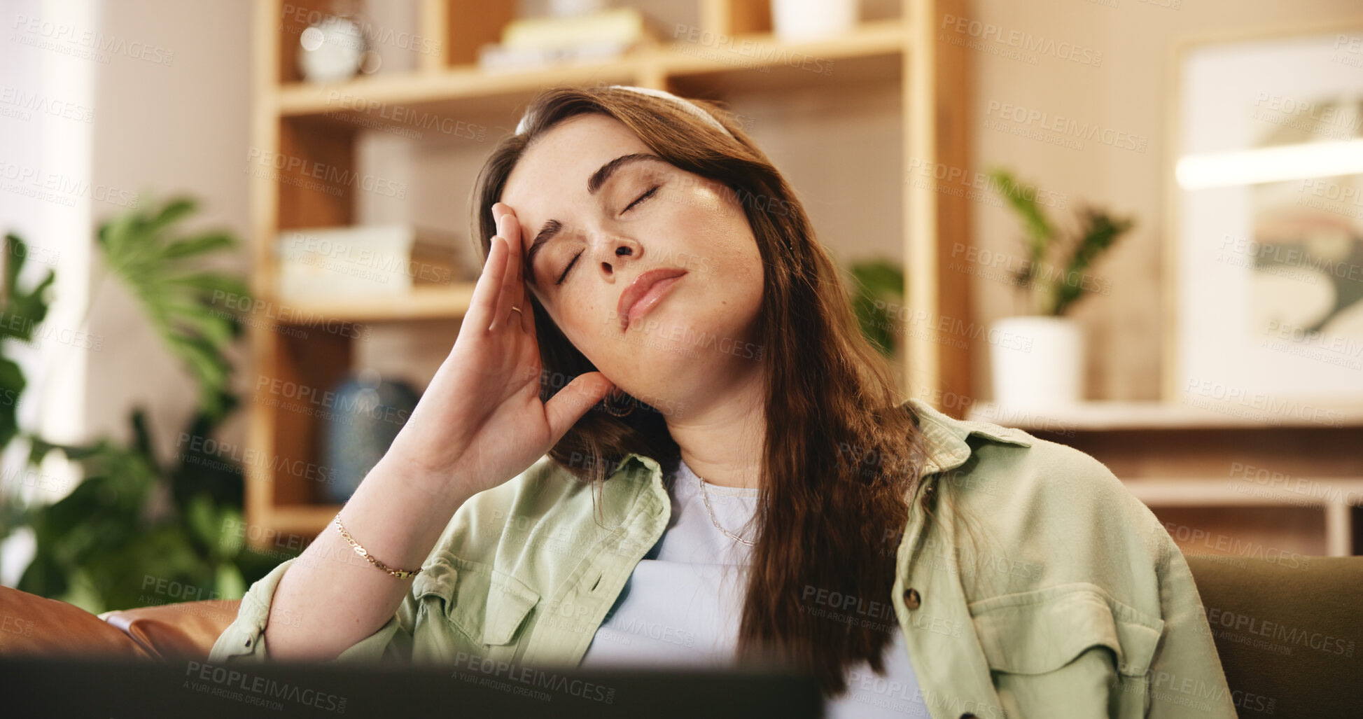 Buy stock photo Tired, university and woman on sofa with laptop with stress for exam, test and assessment for college. Burnout, home and girl with worry, frustrated and headache for studying, education and learning