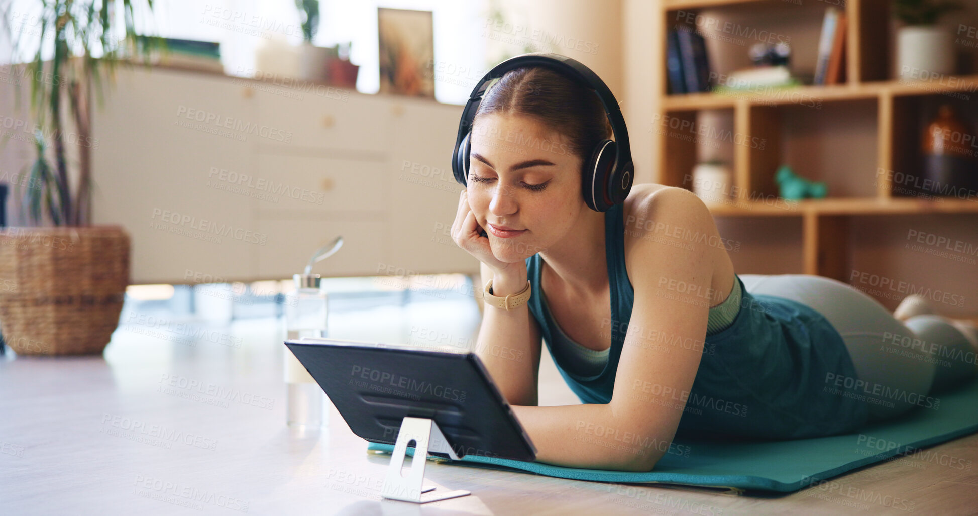 Buy stock photo Yoga, headphones and woman on tablet relax in home for wellness, health and workout for online class. Happy, music and person on floor on digital tech after exercise, training and watching videos