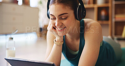 Buy stock photo Fitness, headphones and woman on tablet relax in home for wellness, health and workout for online class. Happy, music and person on floor on digital tech after exercise, yoga and watching videos