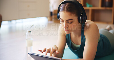 Buy stock photo Yoga, headphones and woman on tablet rest in home for wellness, health and workout for online class. Relax, music and person on floor on digital tech after exercise, training and watching videos