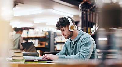 Buy stock photo Man, student and typing on laptop in library for research information, university website and study schedule. Person, online course and headphones of education project, exam results and podcast audio