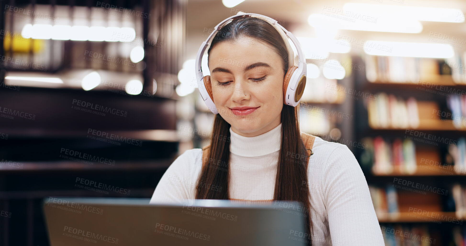 Buy stock photo Woman, student and typing on laptop in library for research information, university website and study schedule. Girl, online course and headphones of education project, exam results and podcast audio