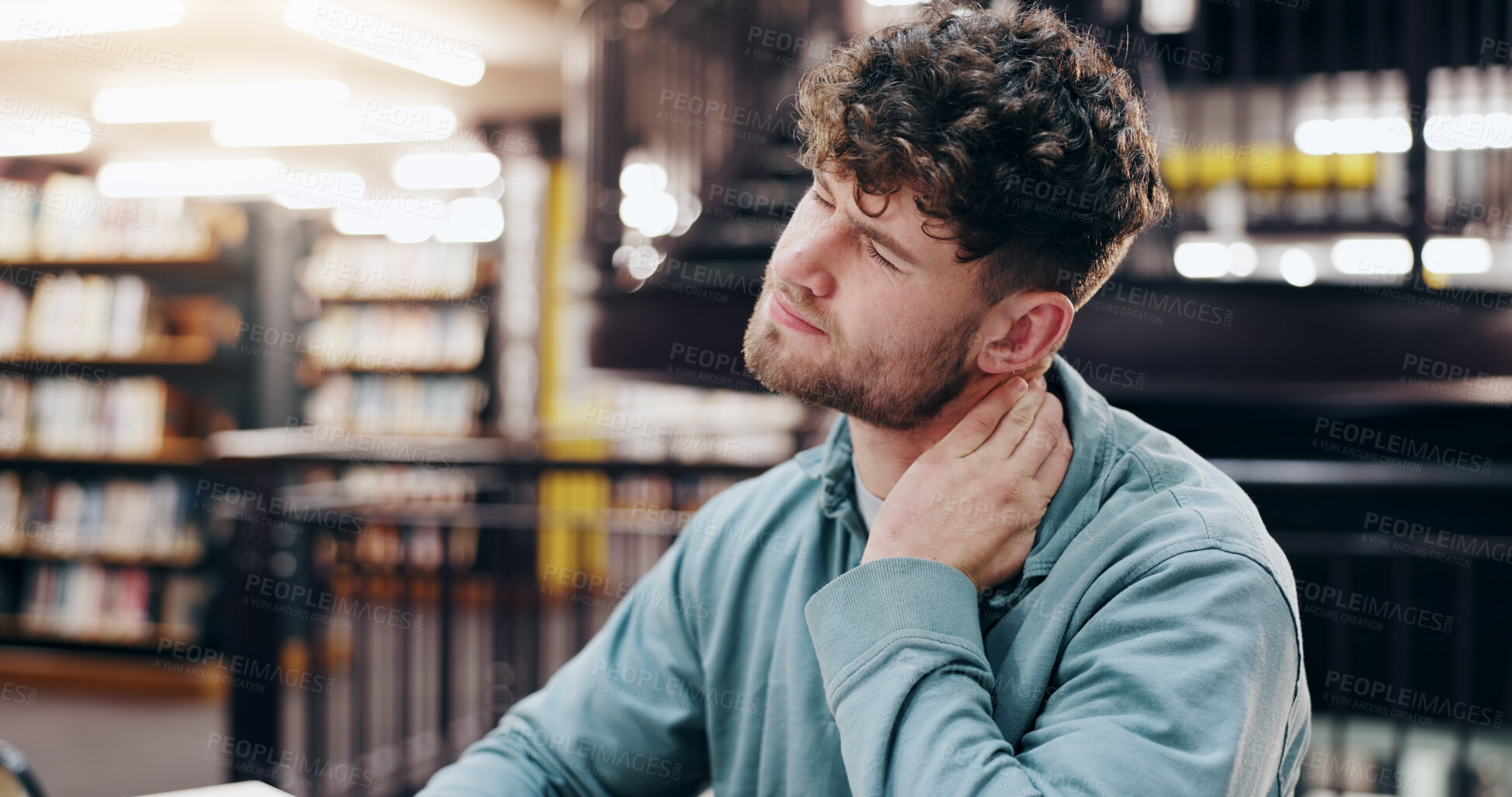 Buy stock photo Neck pain, student and library with burnout, stress and deadline for university exam with injury. Fatigue, tired and tired from studying, learning and worry with financial debt and college fees