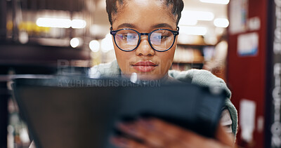 Buy stock photo African, girl and student with tablet in library for research information, university news and study schedule. Woman, digital and reading glasses with education ebook, exam results and project report