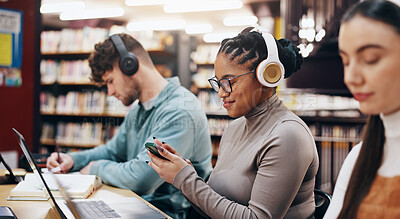 Buy stock photo Cellphone, headphones and woman in library at university reading requirements for scholarship. Audio tech, phone and female student checking results for college test, exam or assignment on campus.