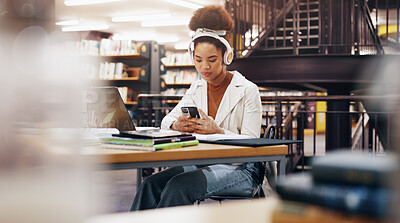 Buy stock photo Phone, headphones and woman in library at university reading requirements for scholarship. Audio tech, cellphone and female student checking results for college test, exam or assignment on campus.