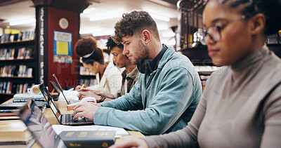 Buy stock photo Education, laptop and typing with student friends in library of university together for learning or study. Computer, development or growth with serious men and women on college campus for scholarship