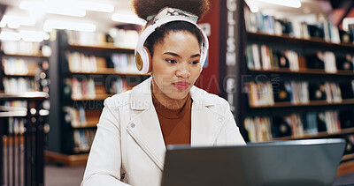 Buy stock photo African, student and typing on laptop in library for research information, university web and study schedule. Girl, online course and headphones for education project, exam results and podcast audio
