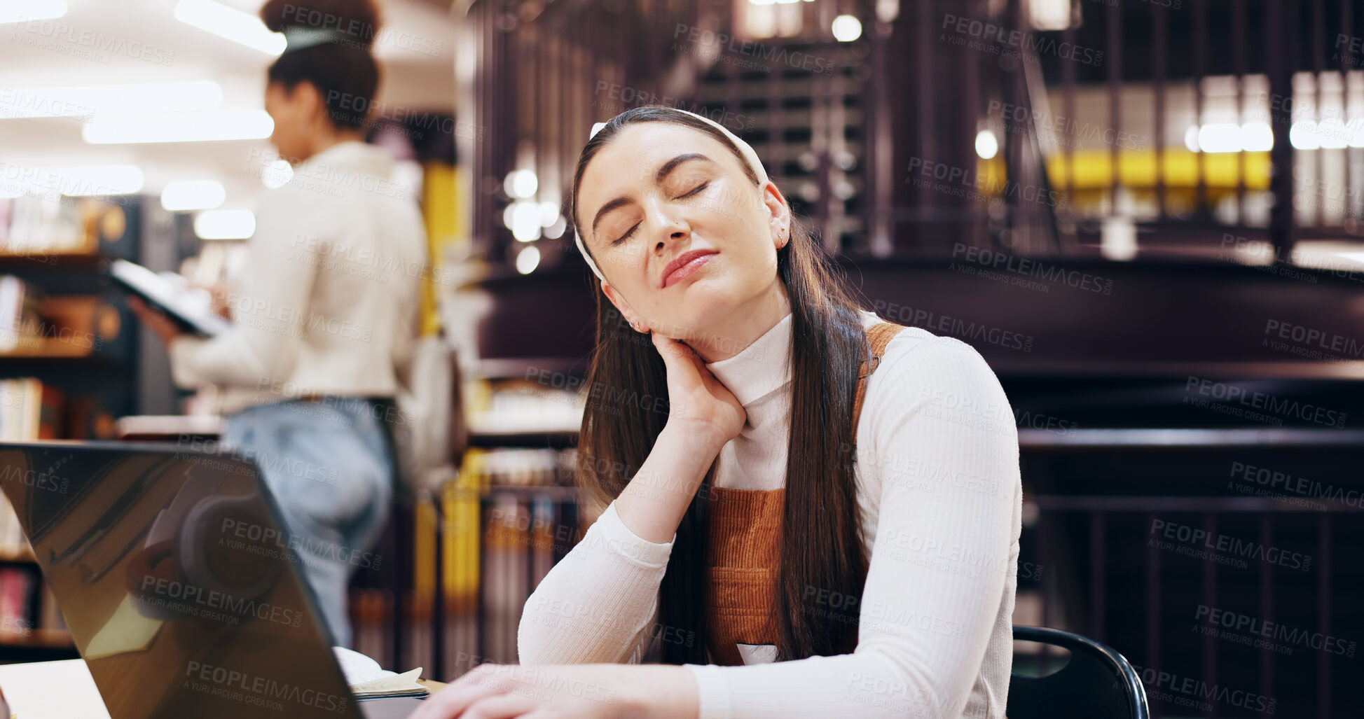 Buy stock photo Woman, university student and neck pain at library with laptop for research, study and revision. Female person, college learner and tired or exhausted with burnout for exams, assignment or assessment