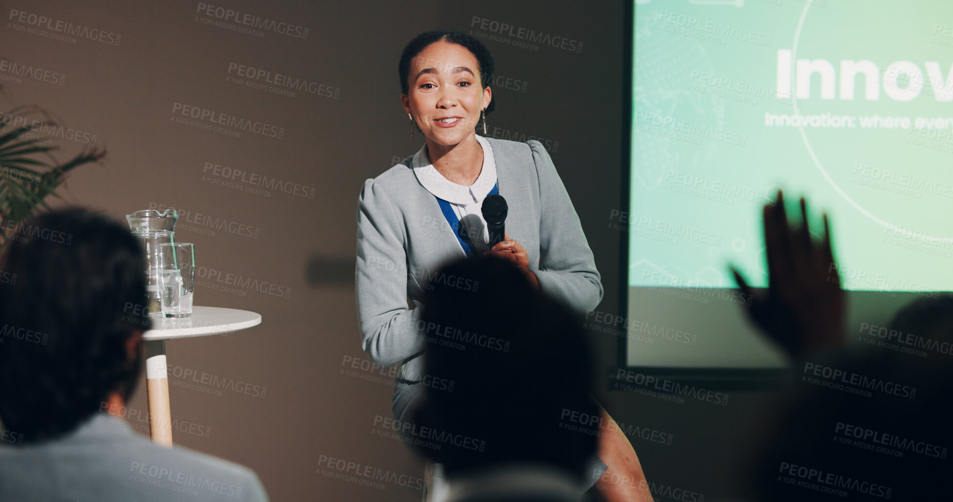 Buy stock photo Woman, stage and question at conference for innovation and future discussion as public speaker. Female person, screen and presentation for global networking, seminar and summit in auditorium