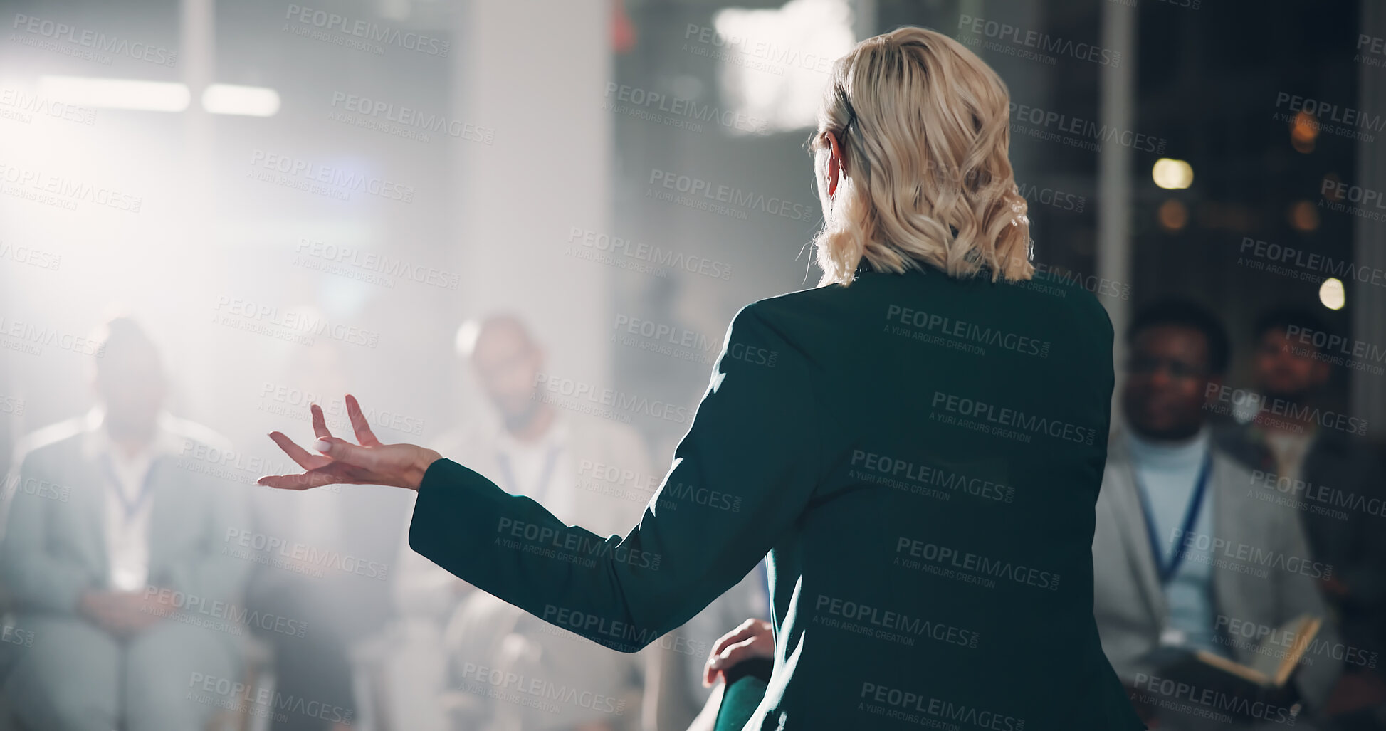 Buy stock photo Back, woman and speaker with presentation for crowd speech, workshop and coaching conference on stage. Professional, presenter and mic for communication, public speaking and lecture of business pitch