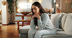 Woman, sad and thinking on sofa in home with depression, break up or remember mistake in living room. Girl, person or unhappy with broken heart on couch for failure, regret and mental health in house