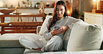 Woman, phone and typing on sofa in home with text message, social media post or online dating app. Girl, person and relax with smartphone on couch for mobile chat, communication and internet browsing