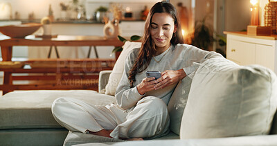 Buy stock photo Woman, phone and typing on sofa in home with text message, social media post or online dating app. Girl, person and relax with smartphone on couch for mobile chat, communication and internet browsing