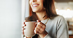 Woman, hands and smile with coffee in home for relax, morning caffeine and thinking by window. Girl, person and drinking tea in house for inspiration, happy memory and daydreaming to unwind in lounge