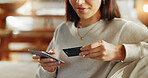 Woman, phone and credit card with hands on sofa for online shopping, digital payment and internet banking in home. Girl, person and smartphone for debit purchase, electronic transaction and ecommerce