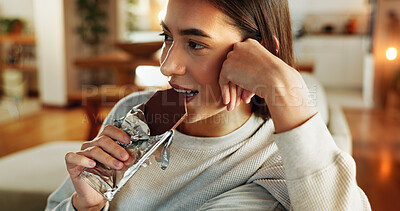 Buy stock photo Chocolate, smile and thinking with woman on sofa in living room of home for relax or wellness. Candy bar, idea and vision with face of happy person eating sweets in apartment for weekend time off