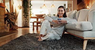 Buy stock photo App, smile and social media with woman on floor in living room of home for communication or online shopping. Relax, search and wellness with happy person in apartment for networking or text message