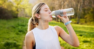 Buy stock photo Woman, calm and drinking water in nature with fitness, hydration or break for thirst. Girl, bottle or liquid on mountain path for electrolytes, refreshment or healthy detox for wellness and nutrition