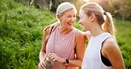 Mature woman, daughter and outdoor on walk for fitness, wellness and exercise in nature with laughing. Female people, conversation and activity together for fresh air, bonding or connection as family